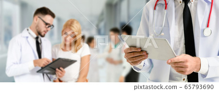 Doctor working in hospital with other doctors. Doctor working in hospital with other doctors. 65793690