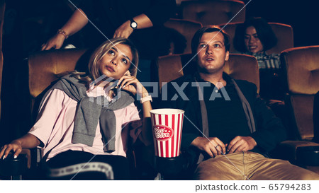 Audience walking to seats in the movie theater. 65794283