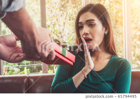 Happy couple giving gift present to celebrate Happy couple giving gift present to celebrate 65794495