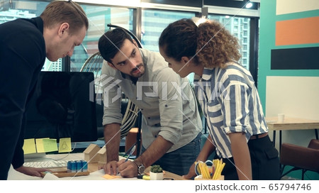 Creative business people group having conversation at office desk. Creative business people group having conversation at office desk. 65794746