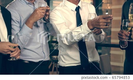 Successful business people drink wine and champagne with team members 65794853