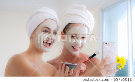 Beautiful woman having a facial treatment at spa. Beautiful woman having a facial treatment at spa. 65795018