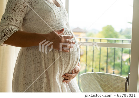 Happy pregnant woman and expecting baby at home. Happy pregnant woman and expecting baby at home. 65795021