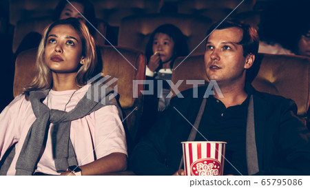People audience watching movie in cinema theater. 65795086