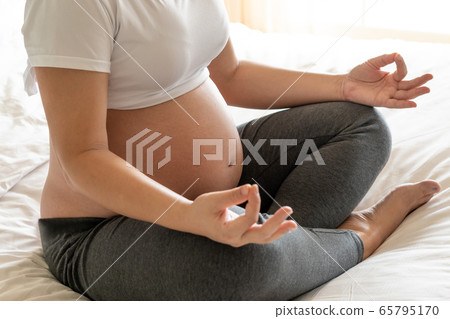 Happy pregnant woman and expecting baby at home. Happy pregnant woman and expecting baby at home. 65795170