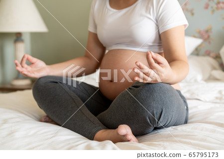 Happy pregnant woman and expecting baby at home. Happy pregnant woman and expecting baby at home. 65795173