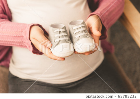 Happy pregnant woman and expecting baby at home. 65795232