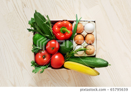 Food in a box on the floor. Food in a box on the floor. 65795639
