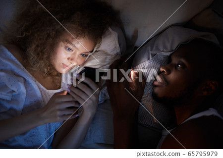 Couple Using Smartphones in Dark Couple Using Smartphones in Dark 65795979