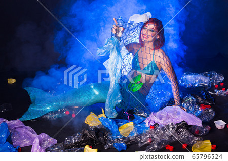 Ocean plastic pollution. Mermaid have fun in water with plastic garbage. Stop plastic pollution. Fairy tale and reality concept. Ocean plastic pollution. Mermaid have fun in water with plastic garbage. Stop plastic pollution. Fairy tale and reality concept. 65796524
