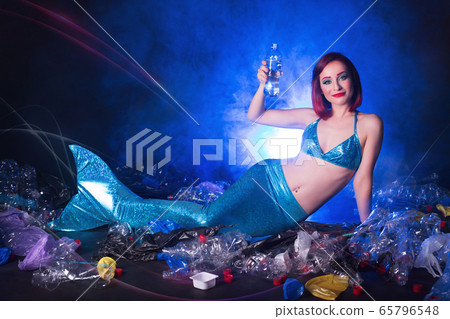Ocean plastic pollution concept. Mermaid lives to polluted habitat. 65796548