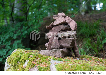 Closeup of stone balance on big rock Closeup of stone balance on big rock 65796676