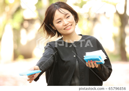 Woman giving out tissue 65796856