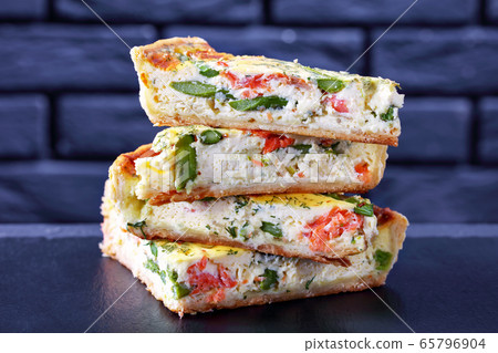 close-up of stack of slices of quiche with salmon 65796904
