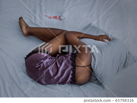 Abdomen and stomach pain during criticals days. African american girl suffering from menstruation Abdomen and stomach pain during criticals days. African american girl suffering from menstruation 65798316