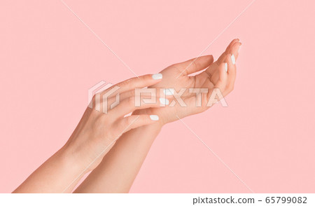 Young woman showing hands with silky skin and perfect manicure on pink background, close up. Panorama Young woman showing hands with silky skin and perfect manicure on pink background, close up. Panorama 65799082