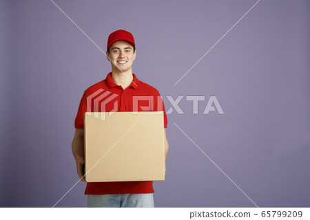 Fast delivery and big parcel. Caucasian post worker gives out big box 65799209
