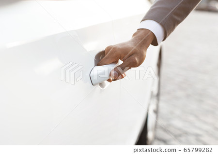 Unrecognizable Black Businessman Opening Automobile Door In City, Cropped Unrecognizable Black Businessman Opening Automobile Door In City, Cropped 65799282
