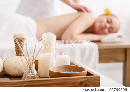 Ayurvedic massage. Bags with herbs, salt and aromatic sticks, close up Ayurvedic massage. Bags with herbs, salt and aromatic sticks, close up 65799296