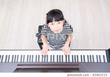 Girls practicing piano 65801515