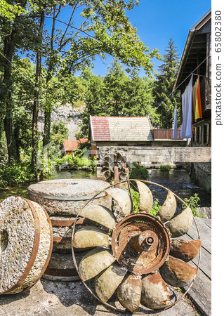 Rusty water wheel at a watermill at Ratoske 65802380