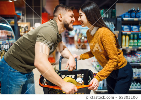 Love couple poses in grocery store 65803100