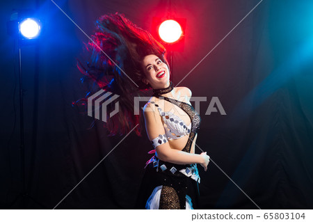 Young woman dancing in Tribal Fusion style. Belly dance on the stage. Young woman dancing in Tribal Fusion style. Belly dance on the stage. 65803104