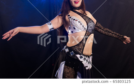 Spirituality dance. Beautiful sexy woman with luxury glossy eastern make-up dancing tribal fusion. Belly dance. Spirituality dance. Beautiful sexy woman with luxury glossy eastern make-up dancing tribal fusion. Belly dance. 65803125