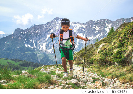 Little boy walks  during an excursion on mountain 65804253