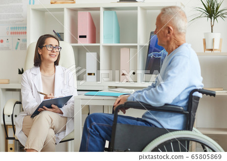 Smiling Doctor Talking to senior Man in Nursing Home Smiling Doctor Talking to senior Man in Nursing Home 65805869