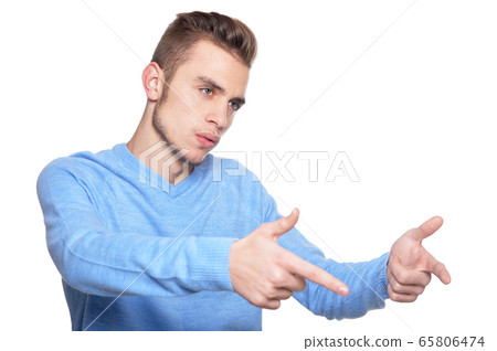 Handsome young man posing against white background 65806474