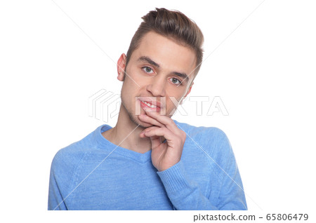 Handsome young man posing against white background Handsome young man posing against white background 65806479
