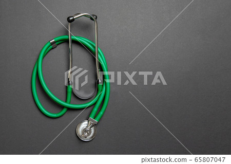 Top view of green medical stethoscope on colorful Top view of green medical stethoscope on colorful 65807047