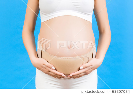 Close up of pregnancy bandage dressed on pregnant Close up of pregnancy bandage dressed on pregnant 65807084