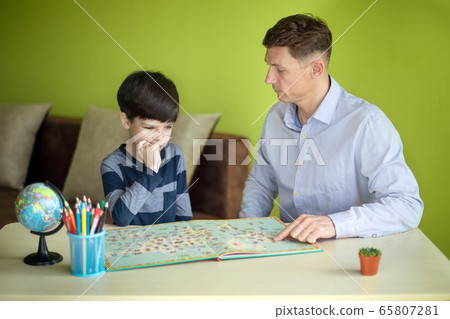 Boy with father doing homework during the quarantine. 65807281