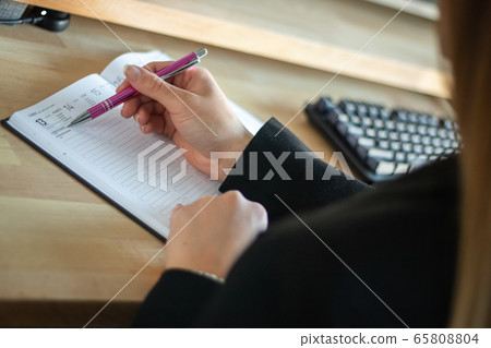 Coronavirus. Home working with computer. female hands writing to notebook Coronavirus. Home working with computer. female hands writing to notebook 65808804