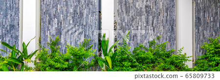 Beautiful background of closeup white gray brick stone wall with green grass. With copy space ideal for use in the design or wallpaper Beautiful background of closeup white gray brick stone wall with green grass. With copy space ideal for use in the design or wallpaper 65809733