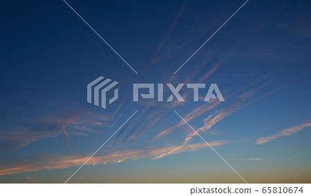 Intense blue sky with small white clouds 65810674