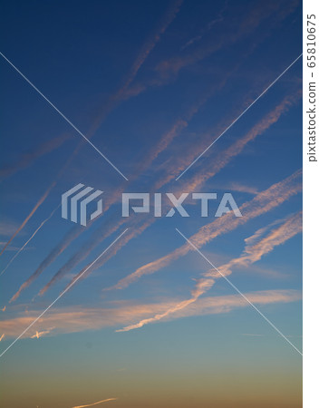 Intense blue sky with small white clouds 65810675