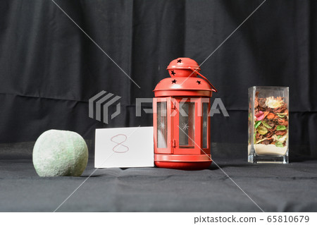Red lantern With bowl with sand. Photographic opening exercise aperture 65810679