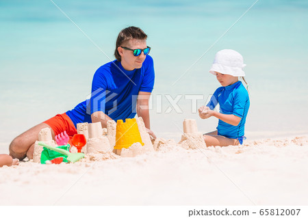 Little girl and happy dad having fun during beach vacation 65812007