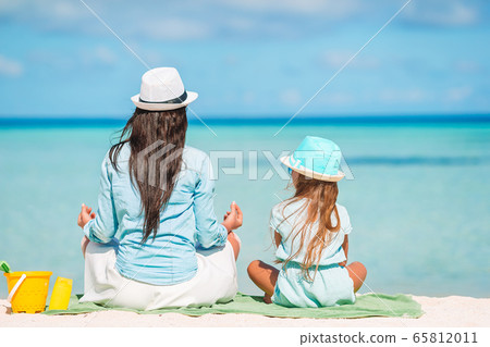 Beautiful mother and daughter at Caribbean beach enjoying summer vacation. Beautiful mother and daughter at Caribbean beach enjoying summer vacation. 65812011