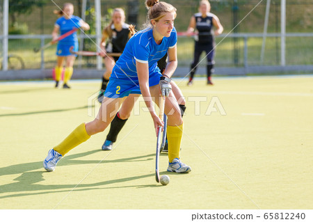 Field hockey female player lead the ball in attack Field hockey female player lead the ball in attack 65812240