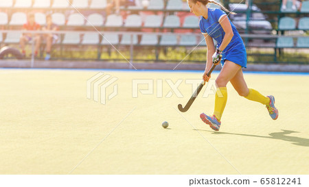 Field hockey female player lead the ball in attack Field hockey female player lead the ball in attack 65812241