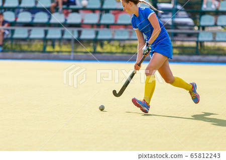 Field hockey female player lead the ball in attack Field hockey female player lead the ball in attack 65812243