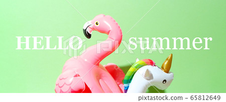 Unicorn, flamingo and pineapple swim tube on green 65812649