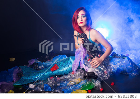 Ocean plastic pollution concept. Mermaid scared due to polluted habitat. 65813808