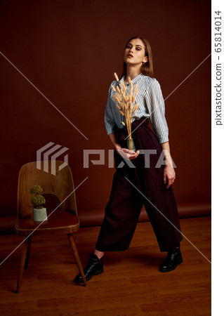 Gorgeous young female in classic suit, black shoes 65814014