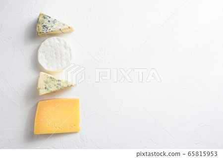 Cheese platter: yellow Maasdam, white Camembert and blue cheese Dor Blue on white background. Copy space. Concept serving cheese. Top view text space for you Cheese platter: yellow Maasdam, white Camembert and blue cheese Dor Blue on white background. Copy space. Concept serving cheese. Top view text space for you 65815953