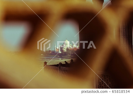 View of Taj Mahal from lattice jali in Agra, Uttar Pradesh, India. retry style effect 65818534